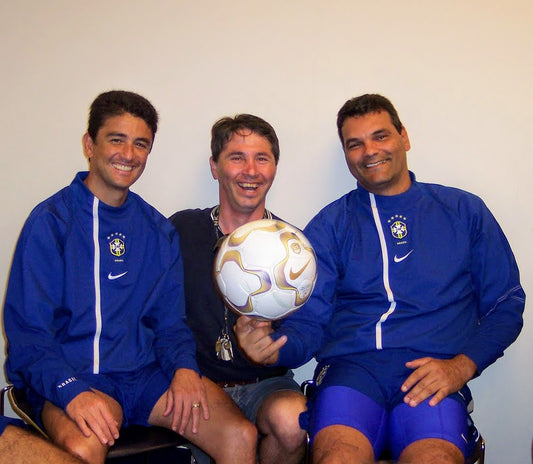 TerraNut co-founder and former professional athlete Ed Bifulco smiles in the center while pointing to a Nike soccer ball, flanked by legendary Brazilian World Cup champion Bebeto on the left and Ricardo Silva on the right