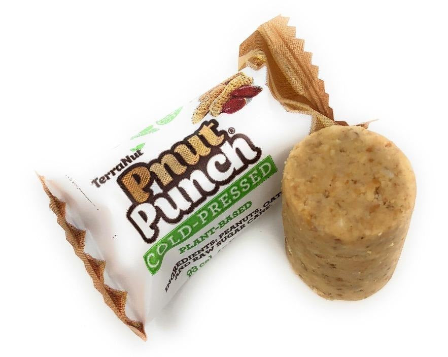 A single TerraNut Pnut Punch cylinder next to its wrapper, emphasizing the simple, raw, and cold-pressed 3-ingredient ground blend.